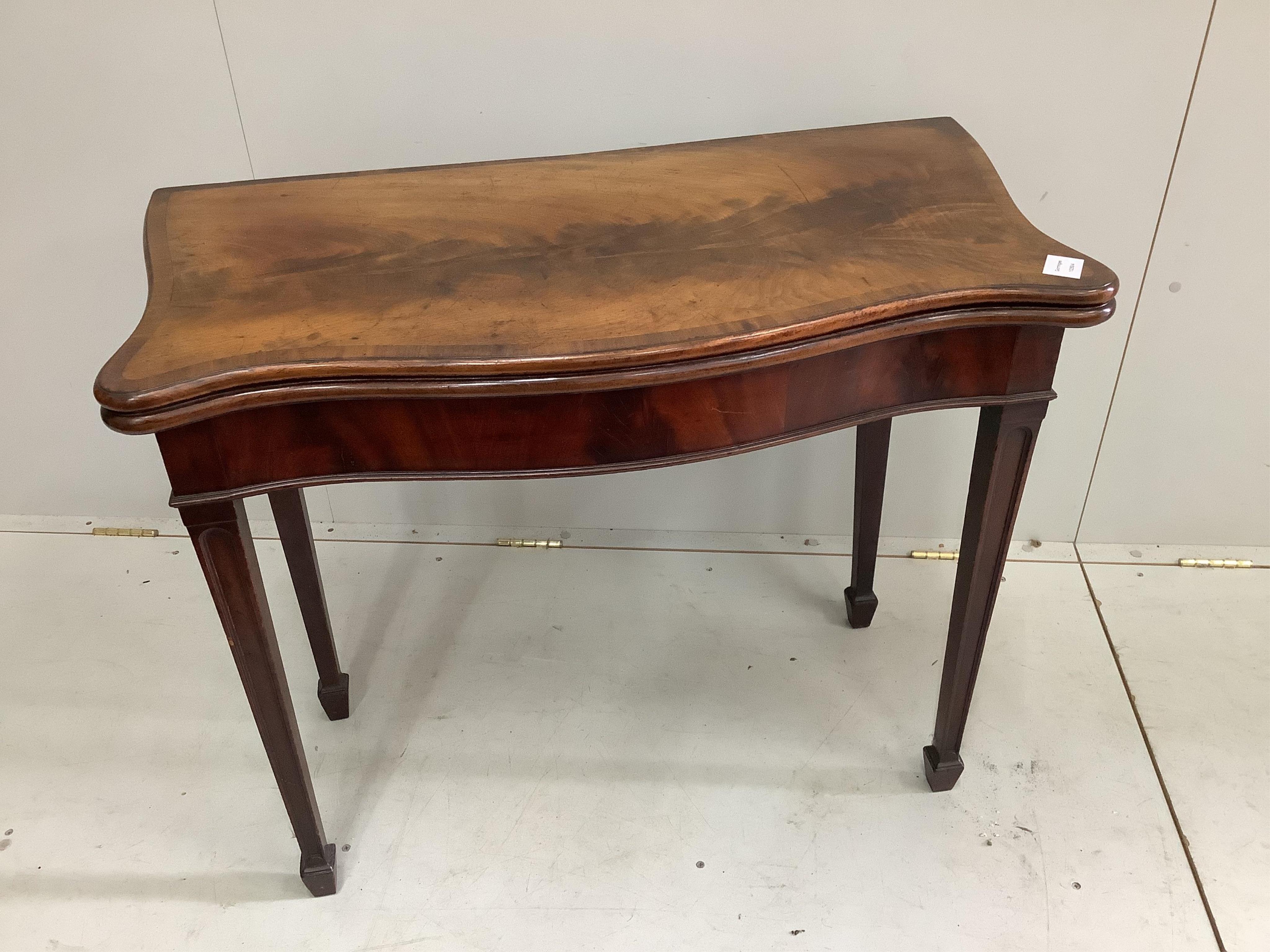 A George III banded serpentine mahogany 'concertina action' folding card table, width 88cm, depth 44cm, height 73cm. Condition - fair